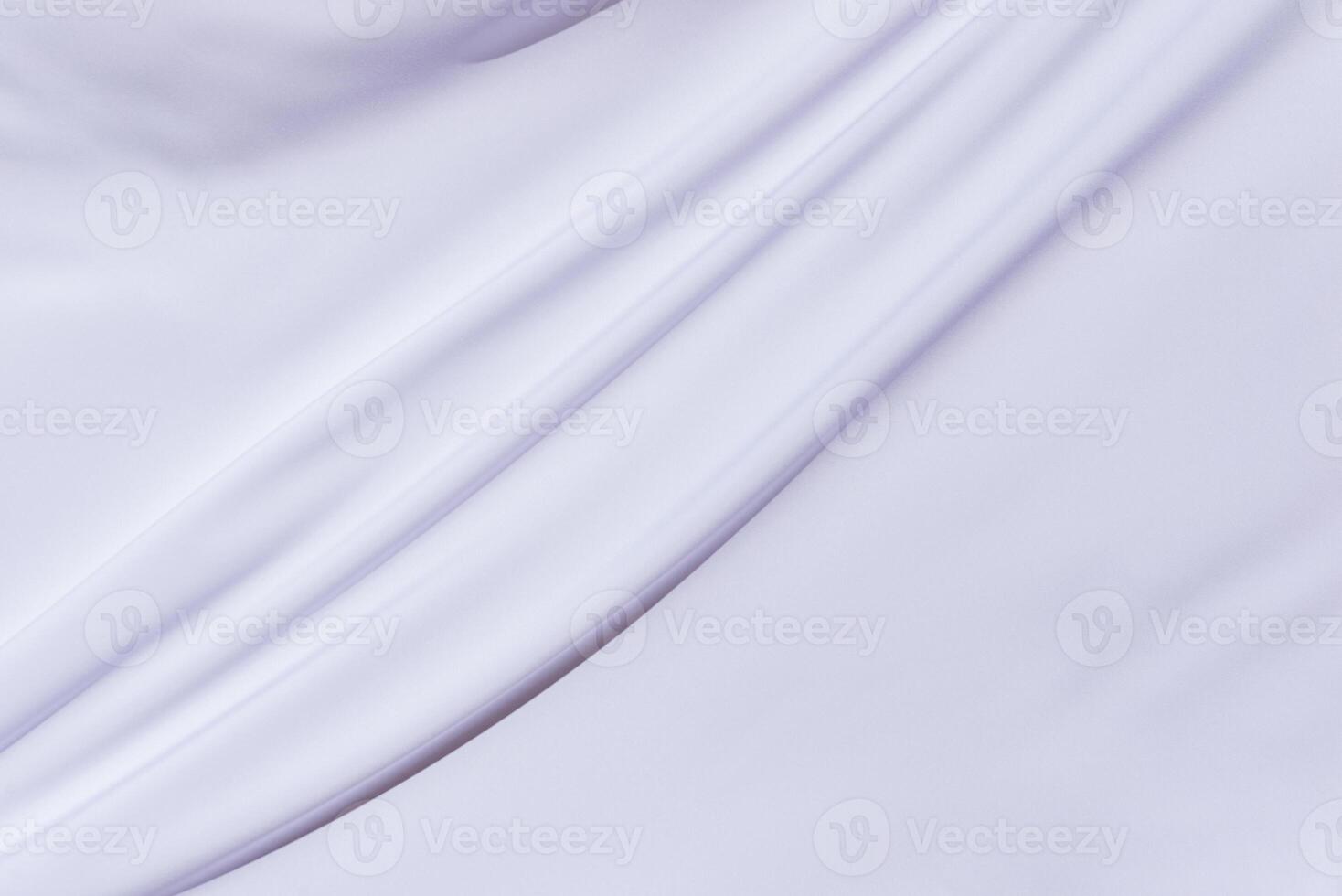 Close-up of smooth white fabric with diagonal folds, perfect for textile visuals, background compositions, or elegant design layers photo
