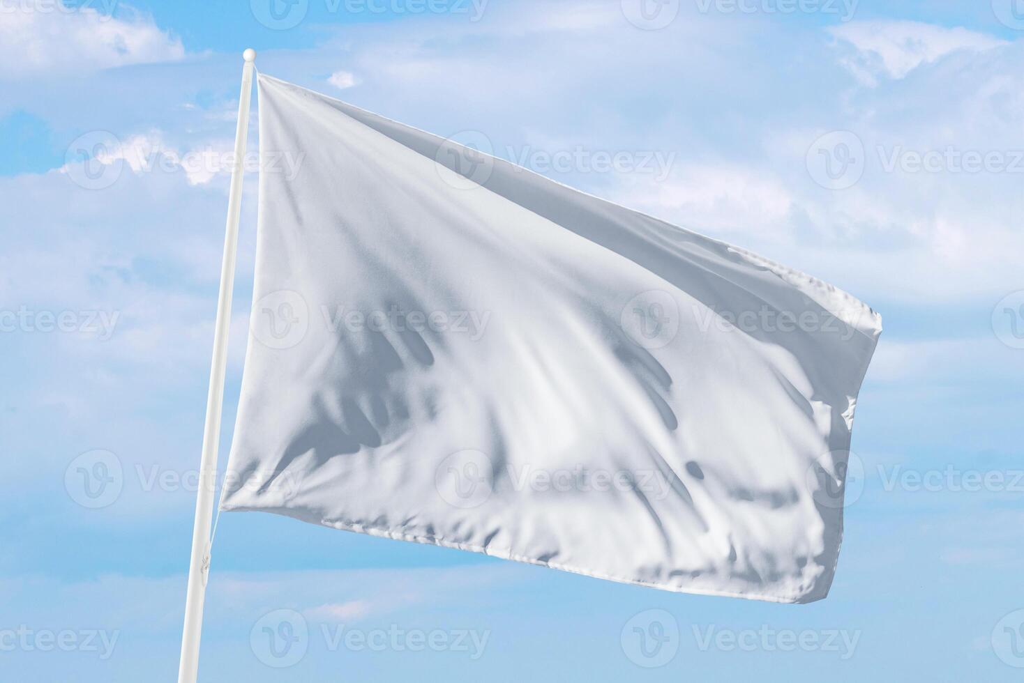 White flag waving under soft clouds, perfect for themes of surrender, calm communication, or neutral design in web or print projects photo