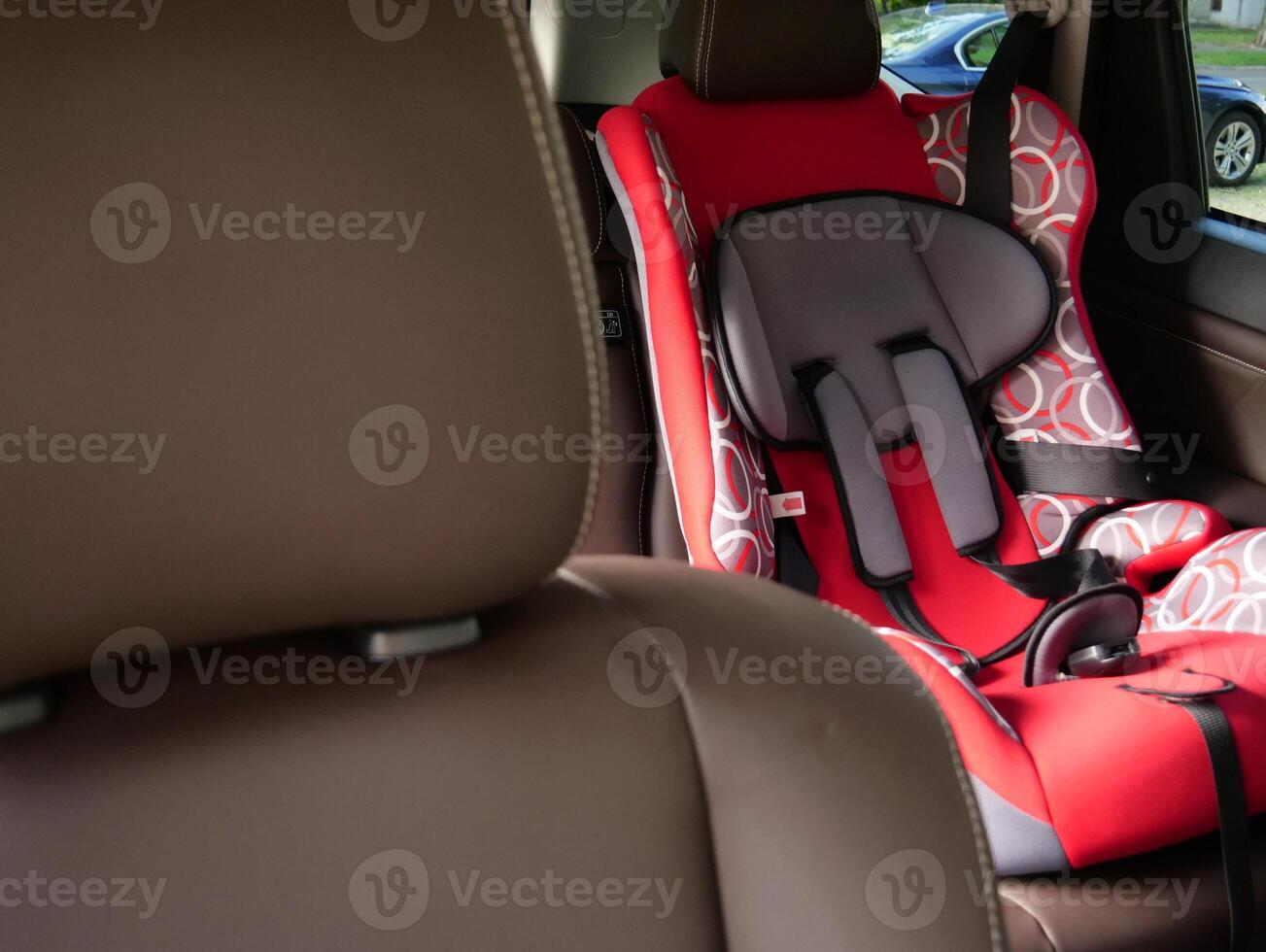 View from the front passenger seat to the child car seat in the back row of car seats photo