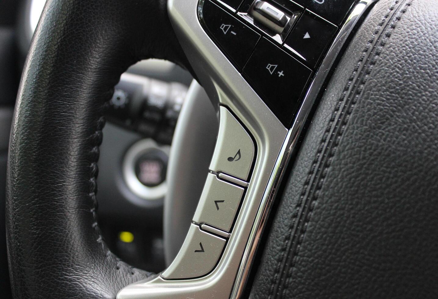 Touch control unit for the volume of the sound system and voice control on the steering wheel of the car photo