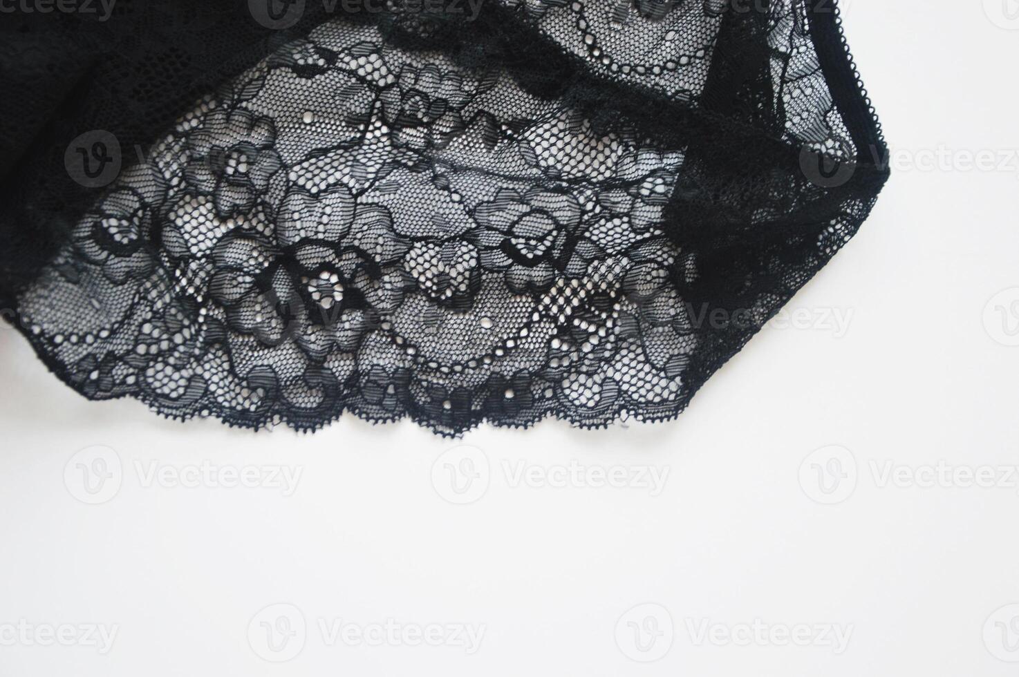 Women's underwear. Fragment of lace of black cotton panties on white background. Beautiful lingerie. photo