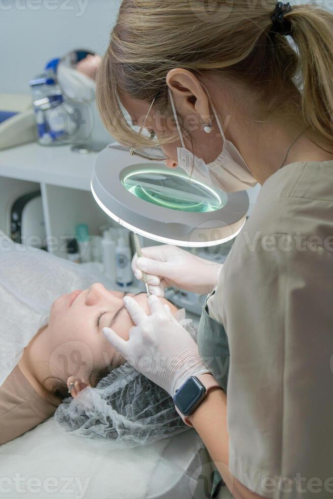 Cosmetologist Clinic Microneedling. Facial treatment, modern clinic, skin rejuvenation. photo