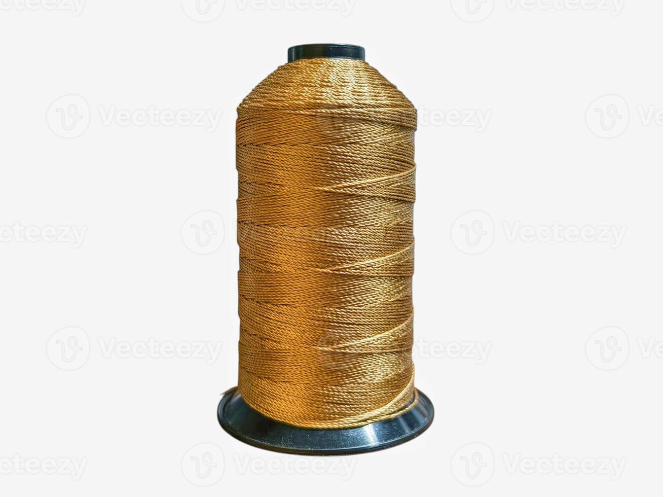 Golden Metallic Thread Spool for Craft and Textile Industry on White Background photo