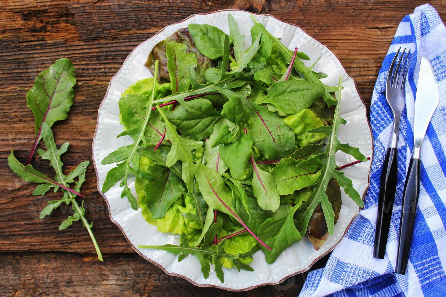 Mix fresh leaves of New Zealand spinach, arugula, lettuce salad . Top view photo
