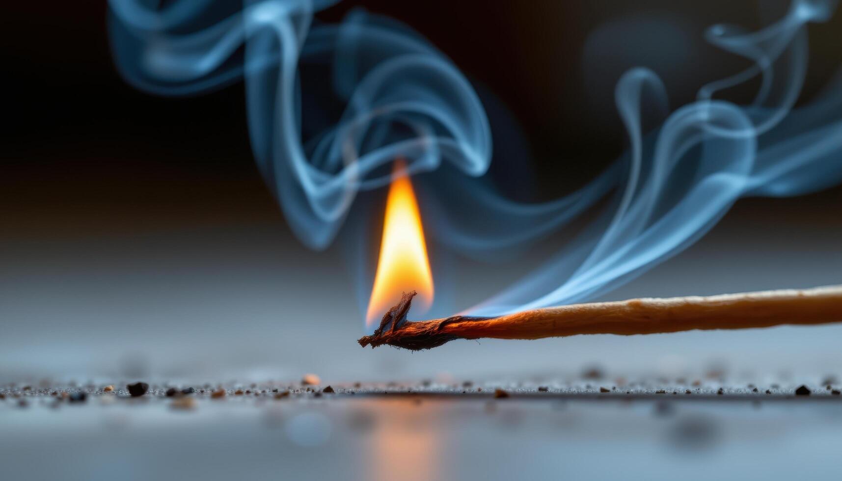 close up view of a tiny flame dancing atop a burning incense stick, the smoke curling and blending with the soft orange glow. photo