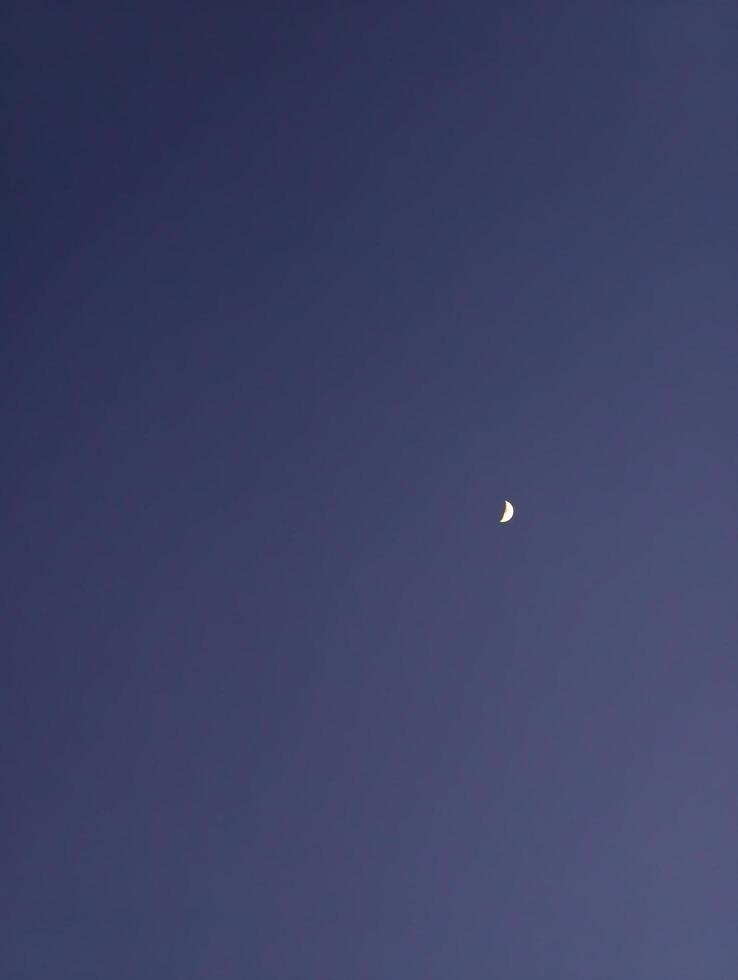 Capture the night sky a crescent moon shining in the dark blue sky photography and astronomy image photo