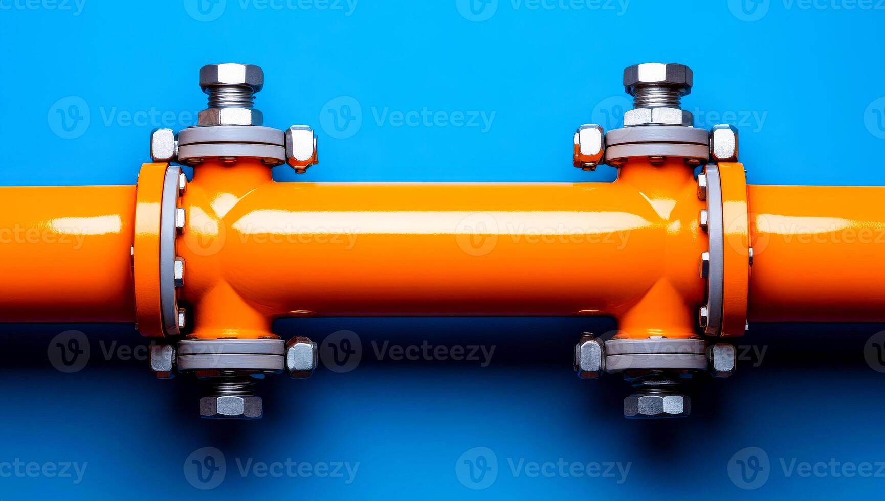 Bright orange pipe with metal fittings. A vibrant orange pipe is secured with silver metal fasteners against a blue background, showcasing industrial design. photo