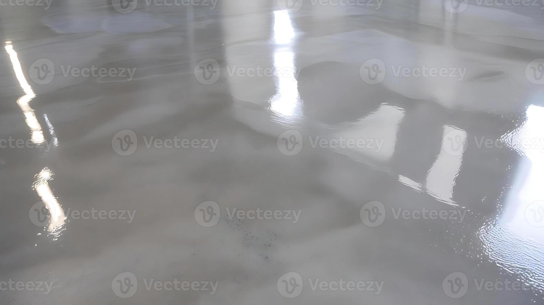 A shiny floor with a reflection of the sun photo