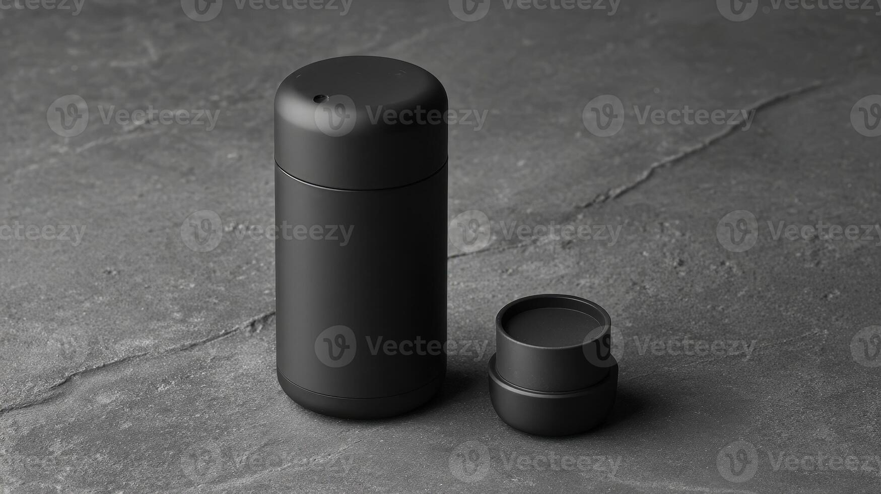 Refillable deodorant container in matte black resting on a dark stone surface, showcasing modern design and functionality photo