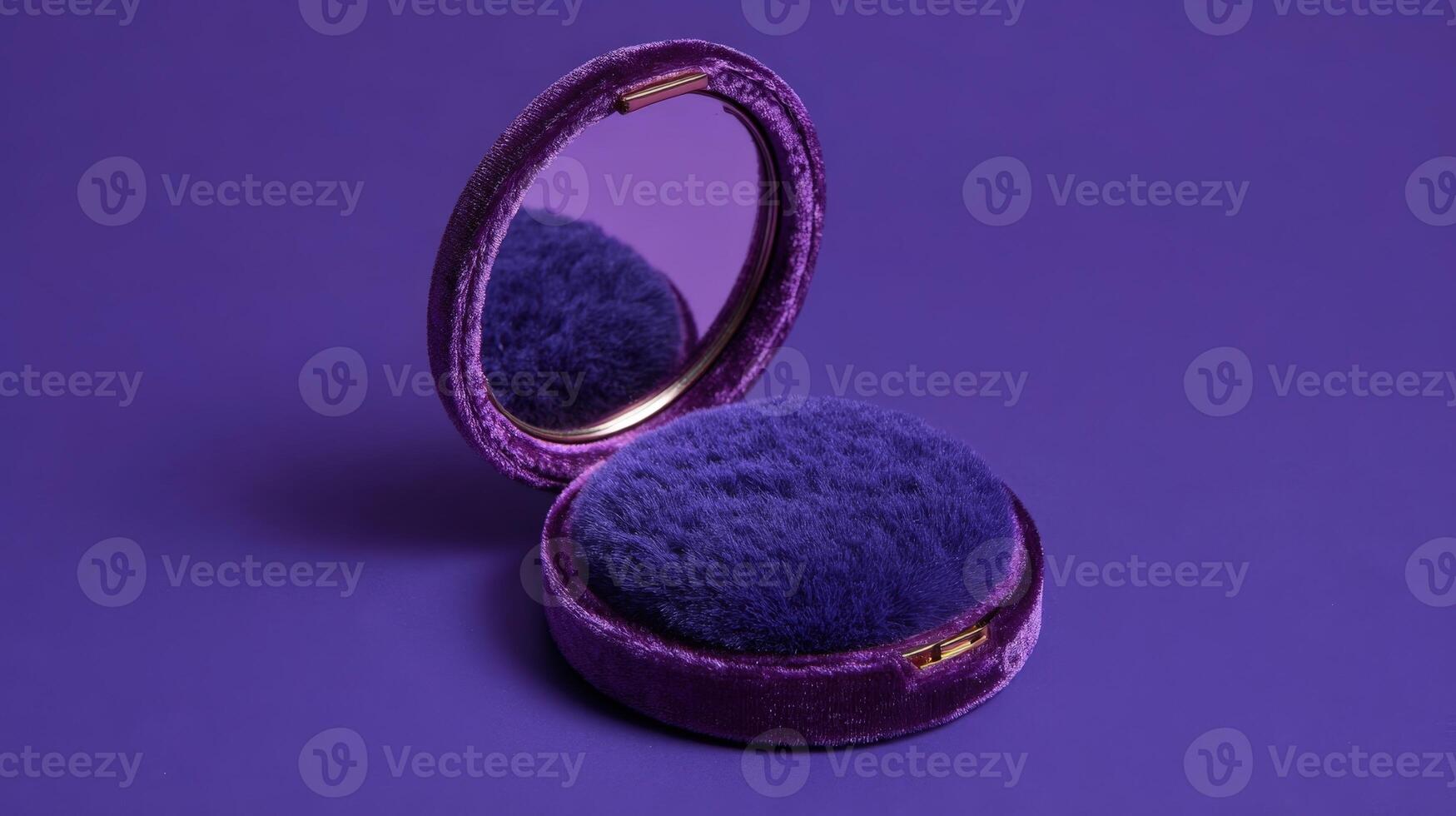 Elegant compact mirror displayed on vibrant purple surface showcasing its soft texture and polished finish for chic grooming essentials photo