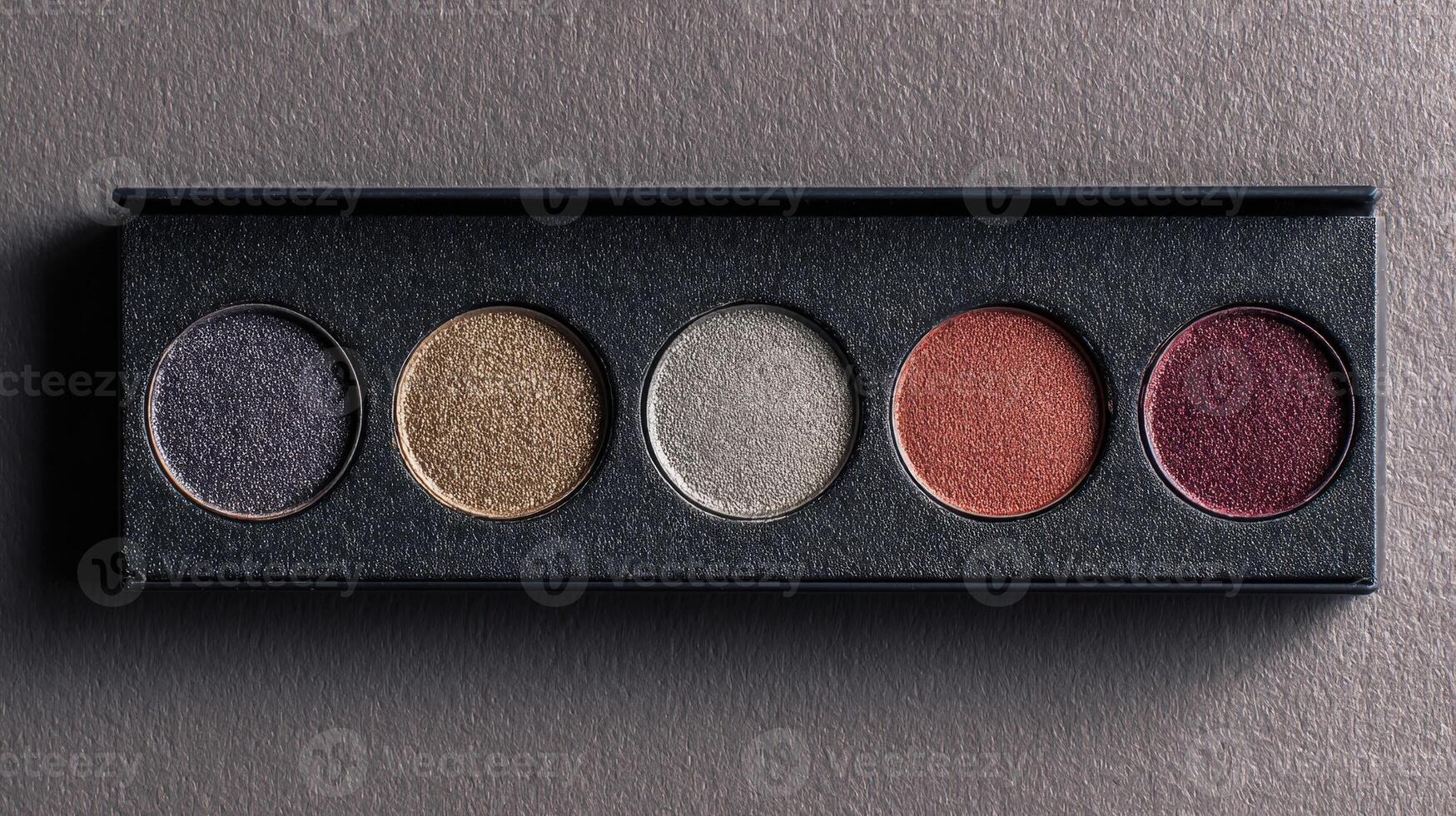 Palette with empty pans awaiting vibrant eye shadows for artistic makeup designs and creative expression in a professional setting photo