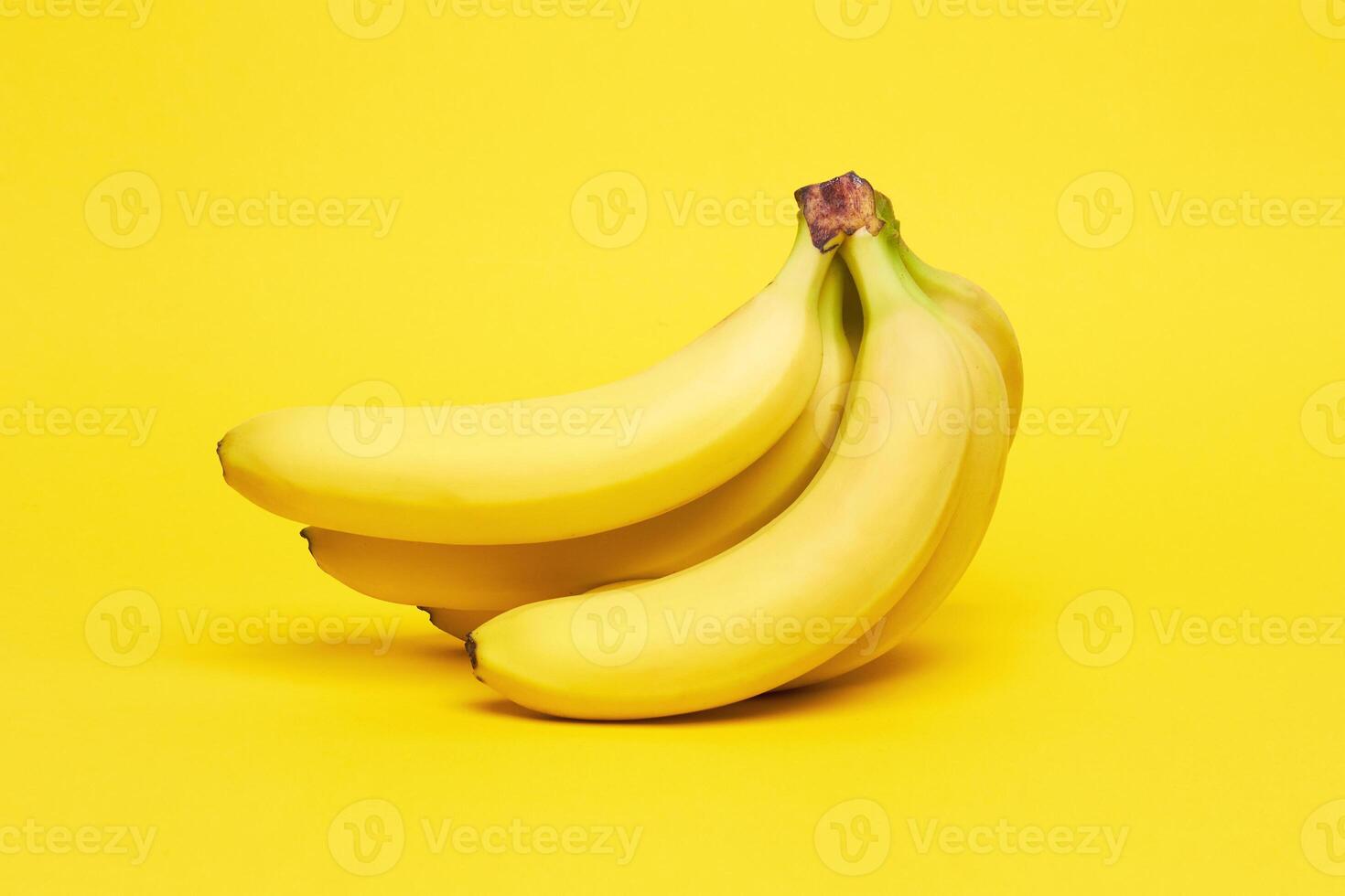 Bananas on yellow background photo