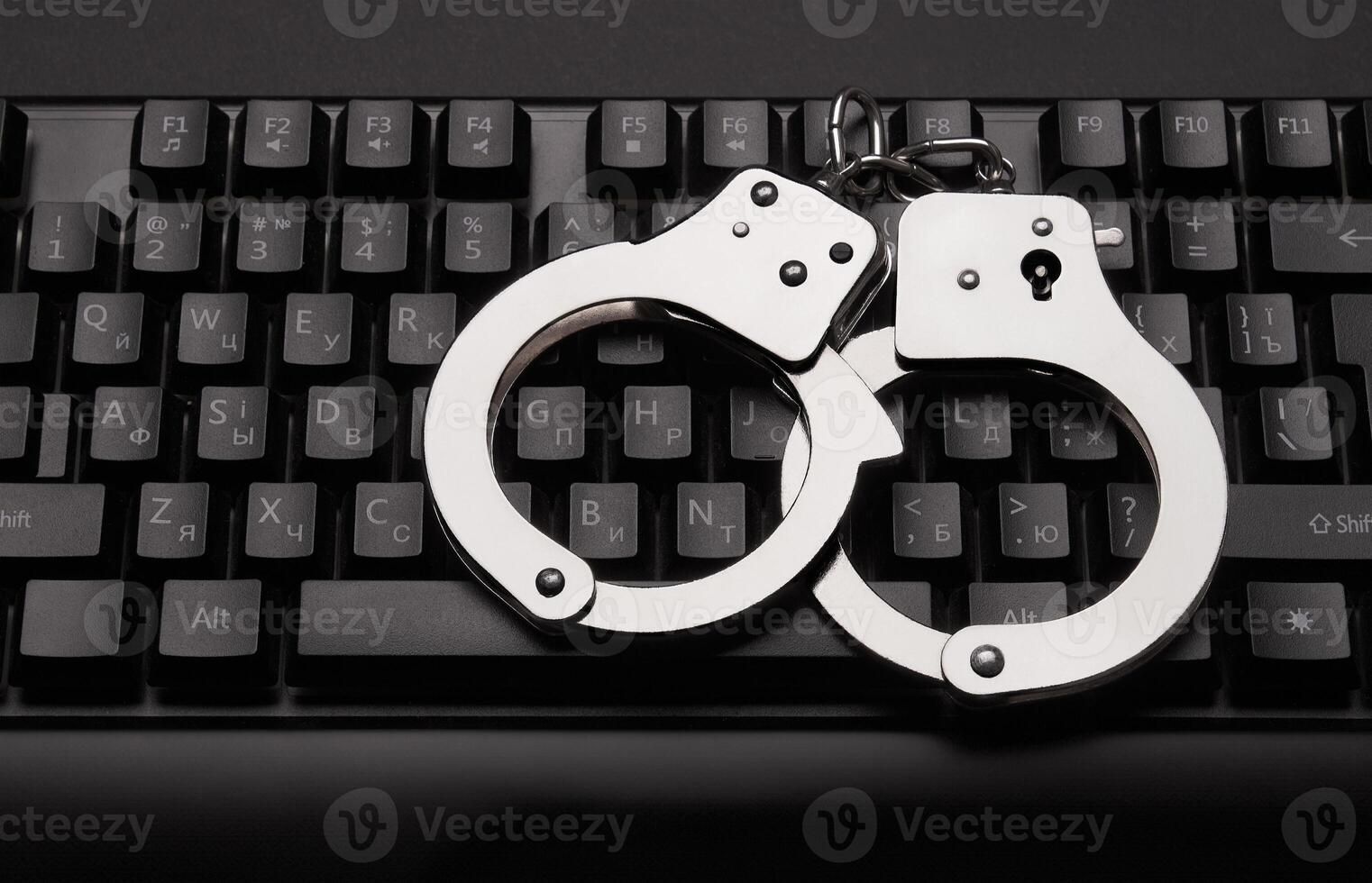 Handcuffs on a keyboard background photo