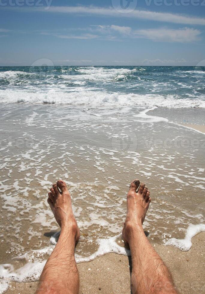 male legs on the beach photo