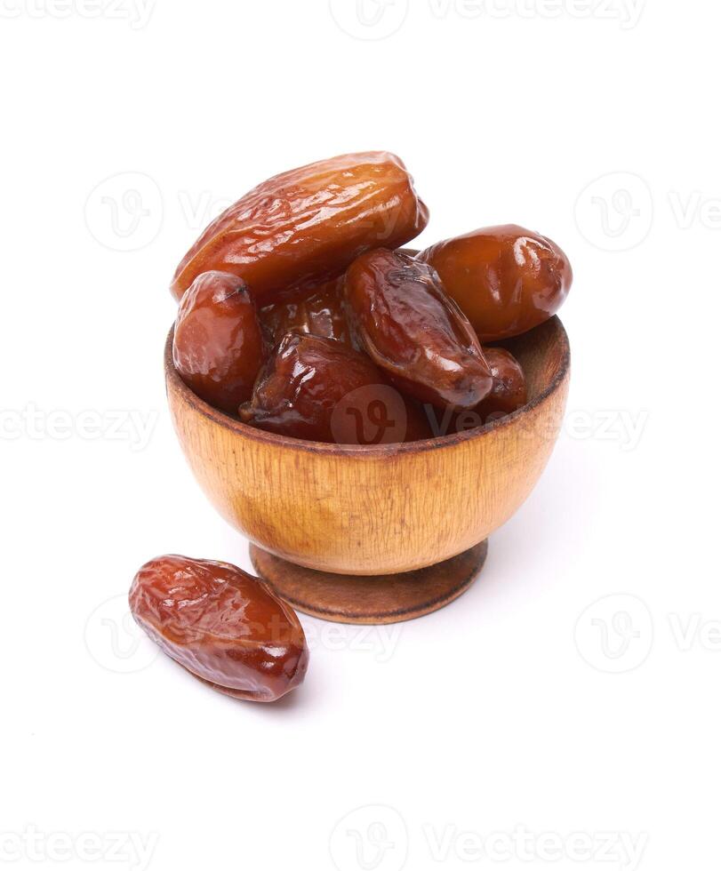 Dried dates fruits in wooden bowl photo