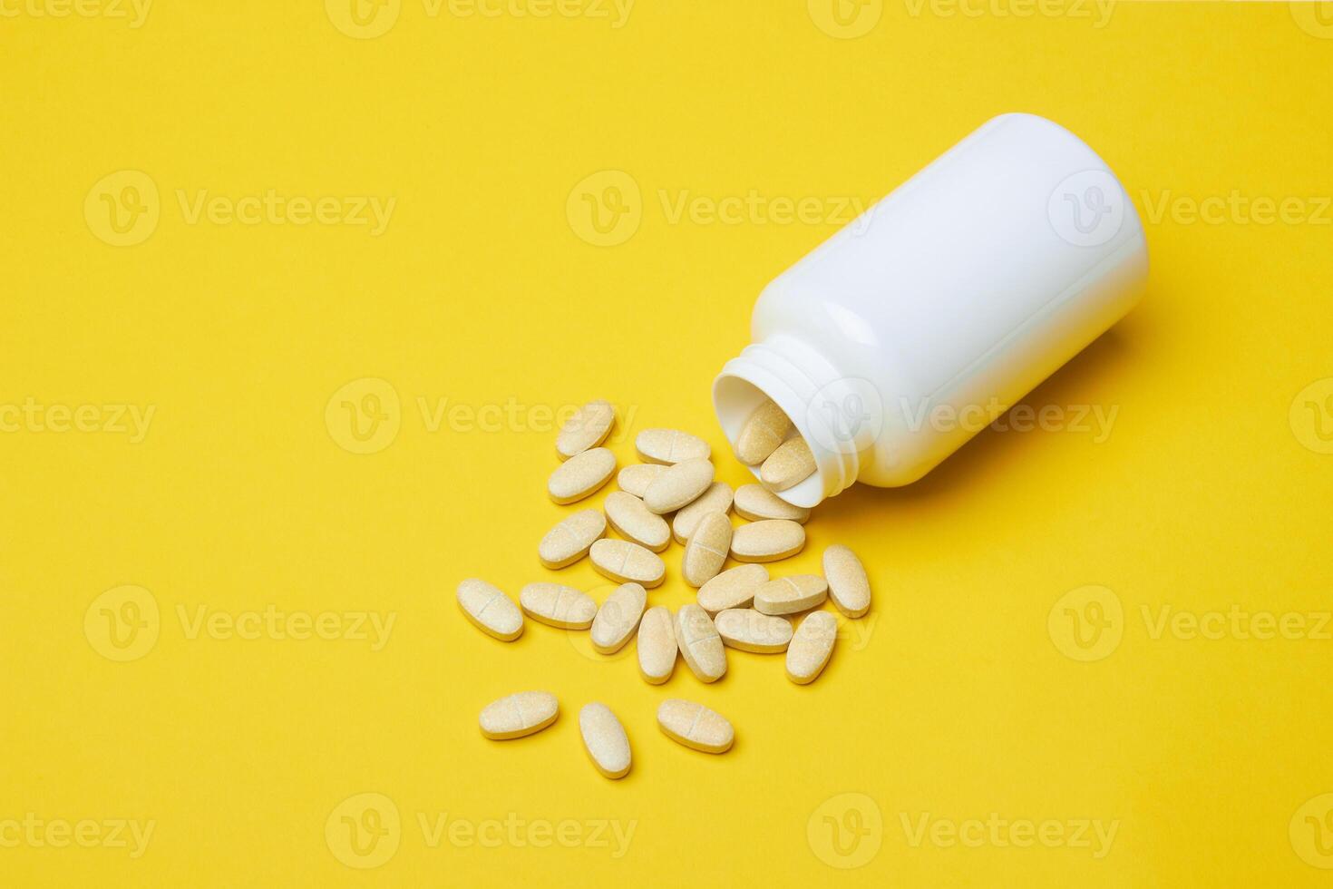 Pills with bottle on a yellow photo