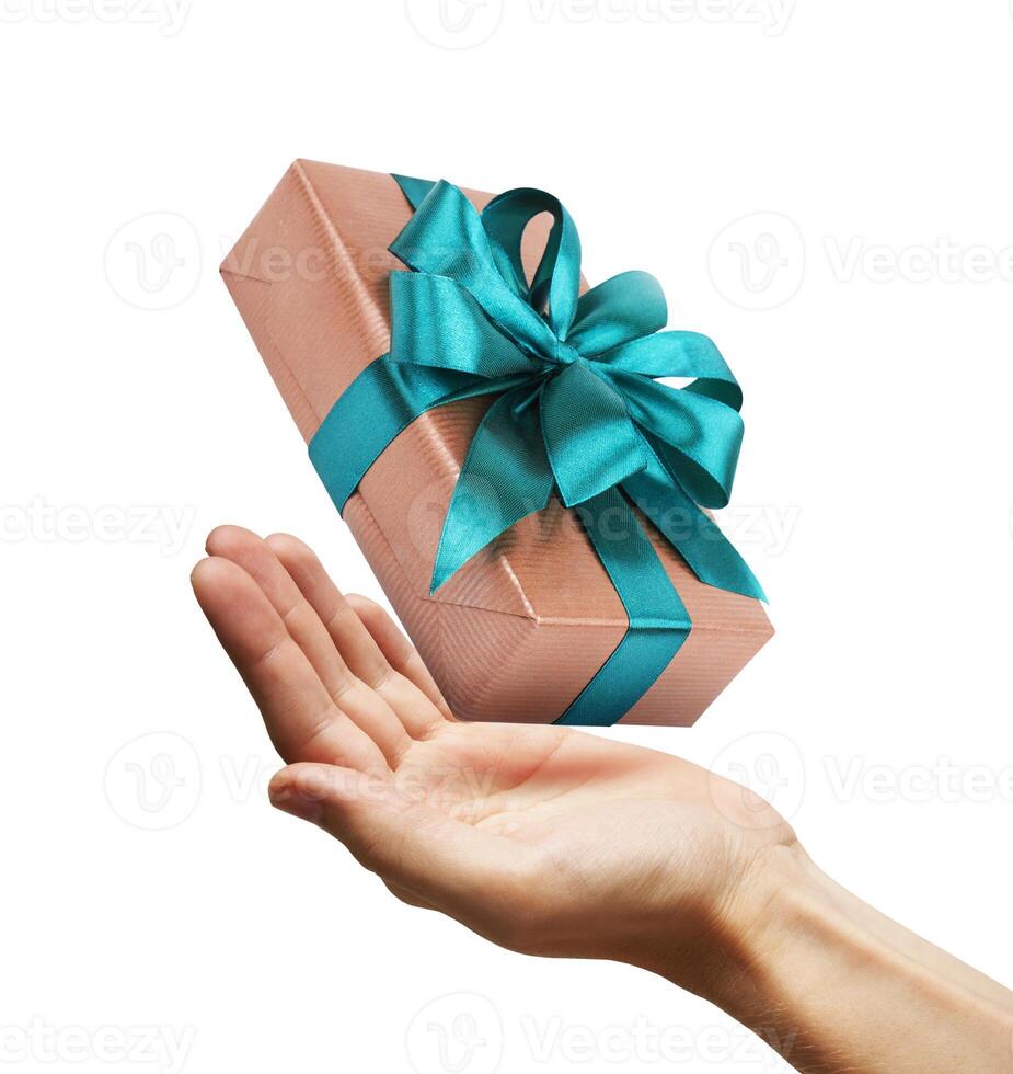Gift box with ribbon in a hand photo