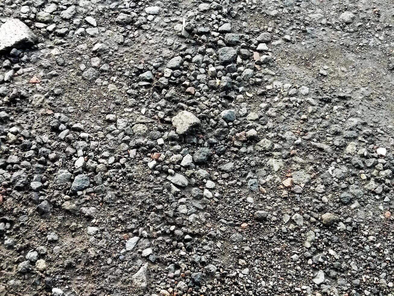 Detailed close up view on pebbles and stones on a gravel ground texture in high resolution photo