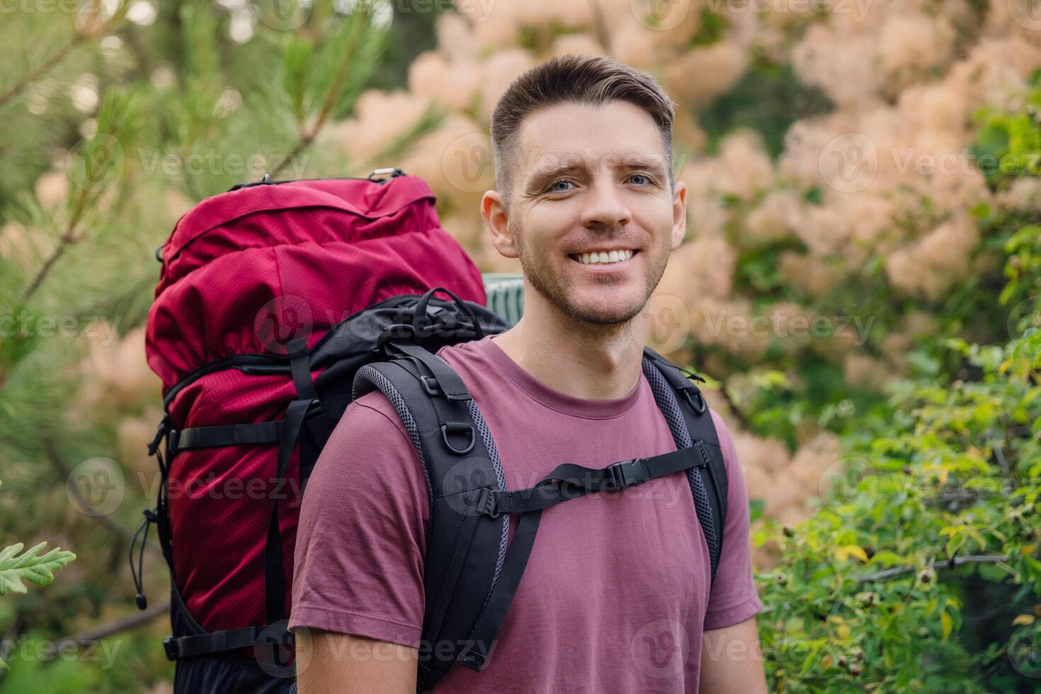 Backpacker smiling in nature photo