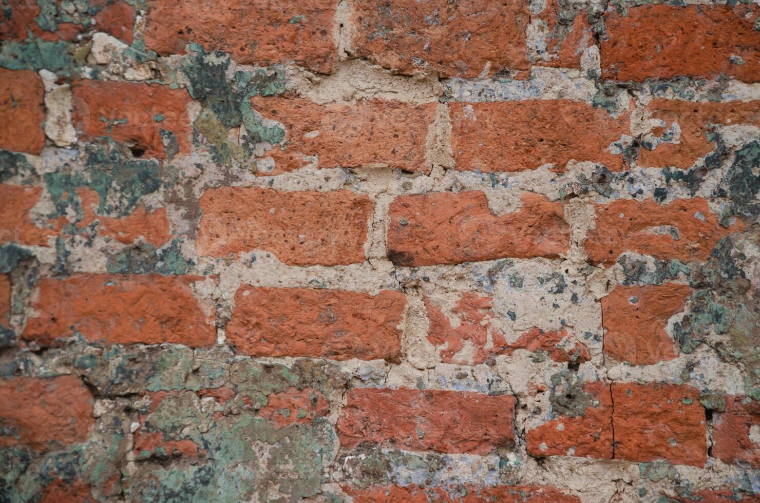 Background of an old brick wall with traces of gray cement. High quality photo