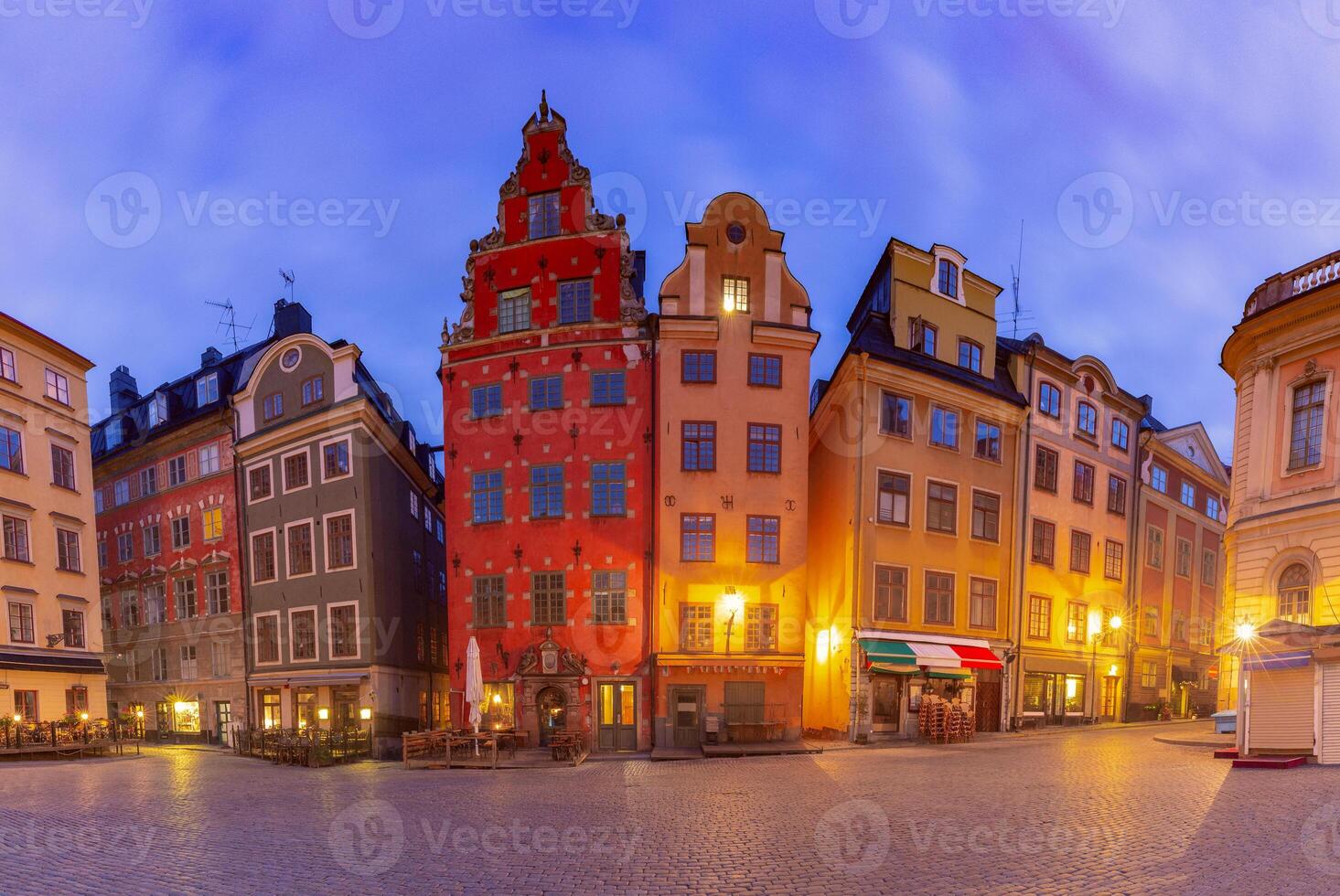 Colorful buildings in a historic square at dusk photo