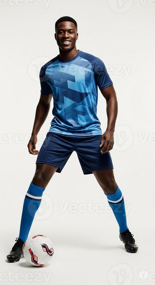 A man in blue soccer uniform posing with a soccer ball photo