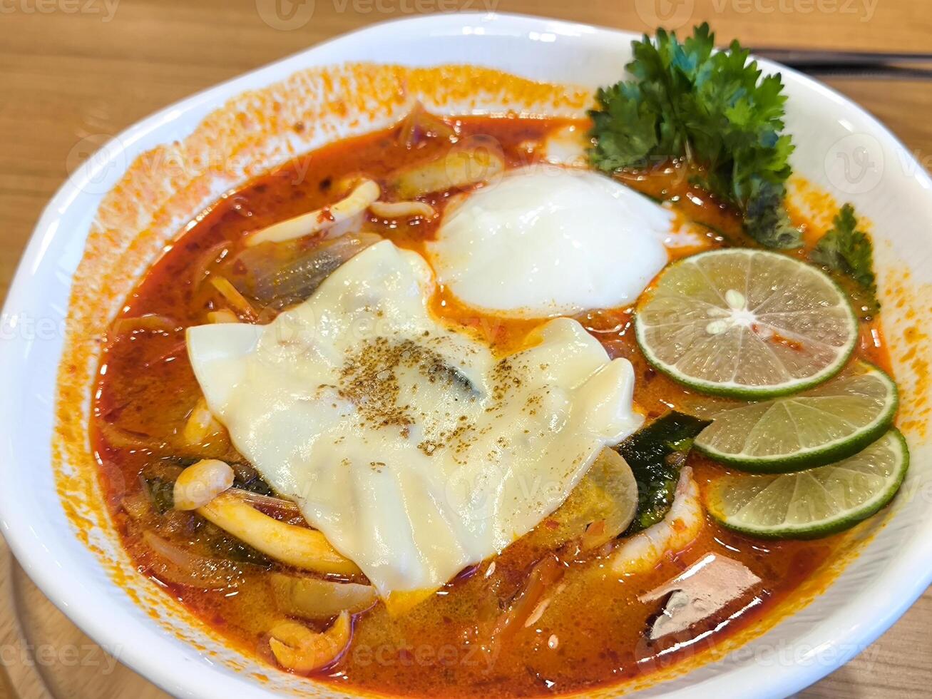 Bowl of Spicy Tom Yum Soup with Egg photo