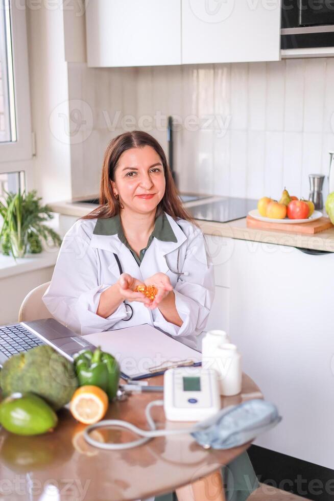 A doctor in a white coat holding a handful of transparent yellow oval capsules in his palms. food supplements, vitamin D, omega-3, fish oil. photo