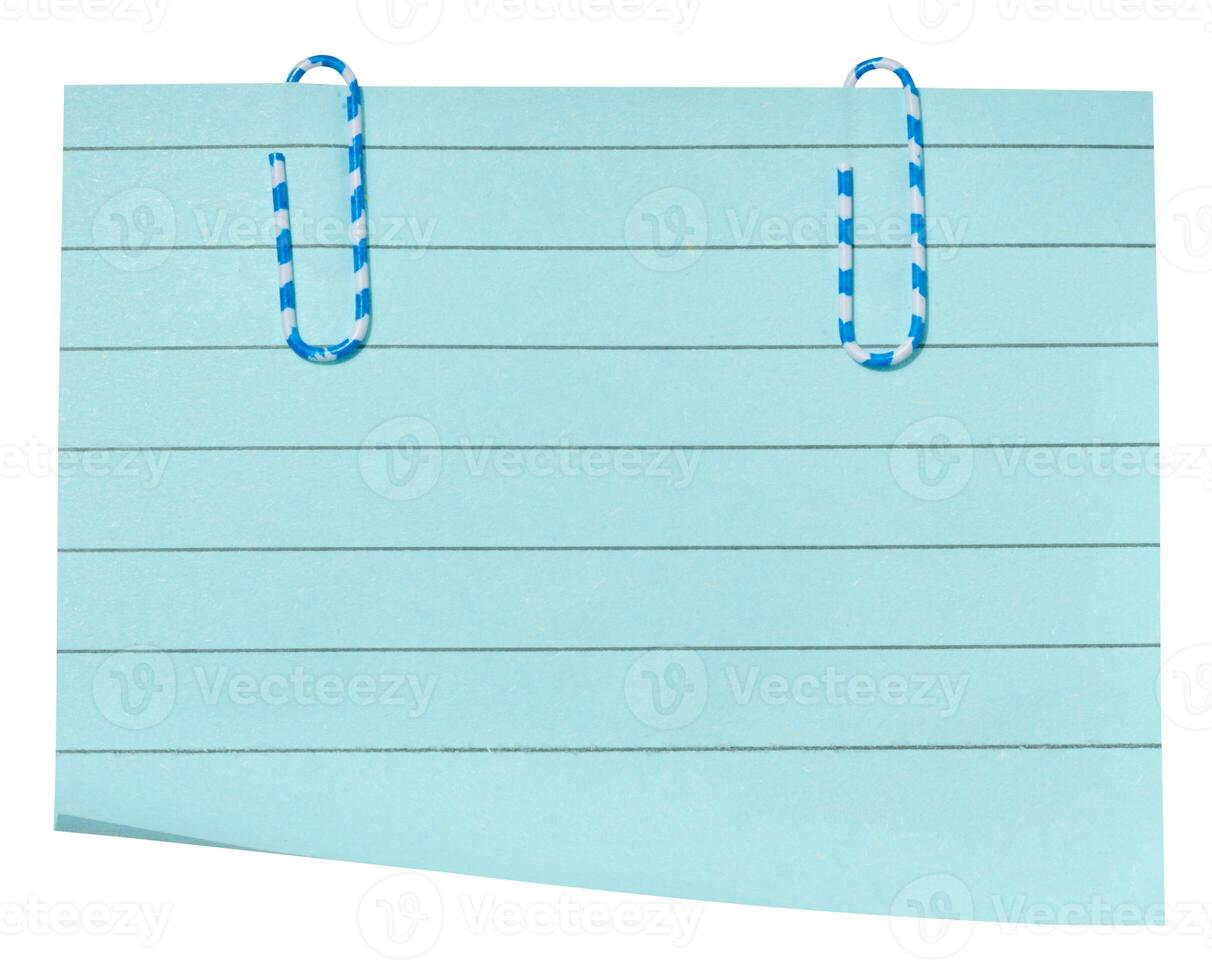 A rectangular sheet of light blue lined paper with two blue and white striped paper clips attached to the top. photo