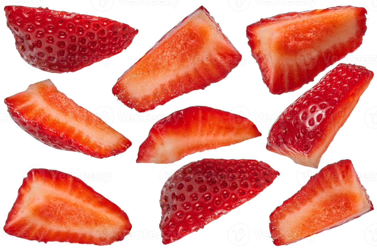 Set of sliced red fresh strawberry wedges arranged in different positions on isolated background photo