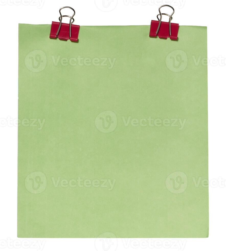 Sheet of green paper attached with two red paper clips binders, isolated background photo