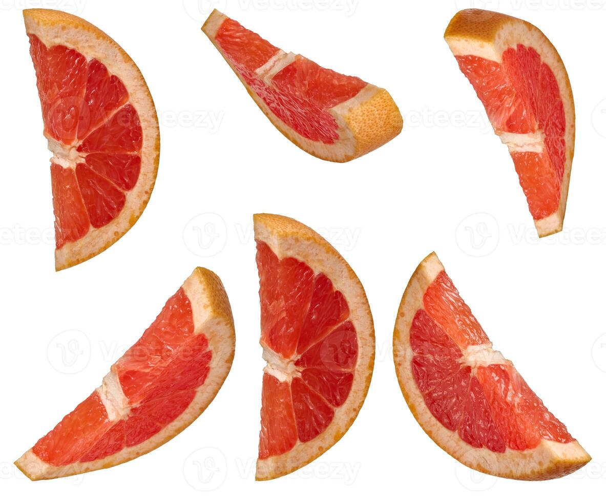 Several sliced red grapefruit wedges from different angles, placed on an isolated background photo