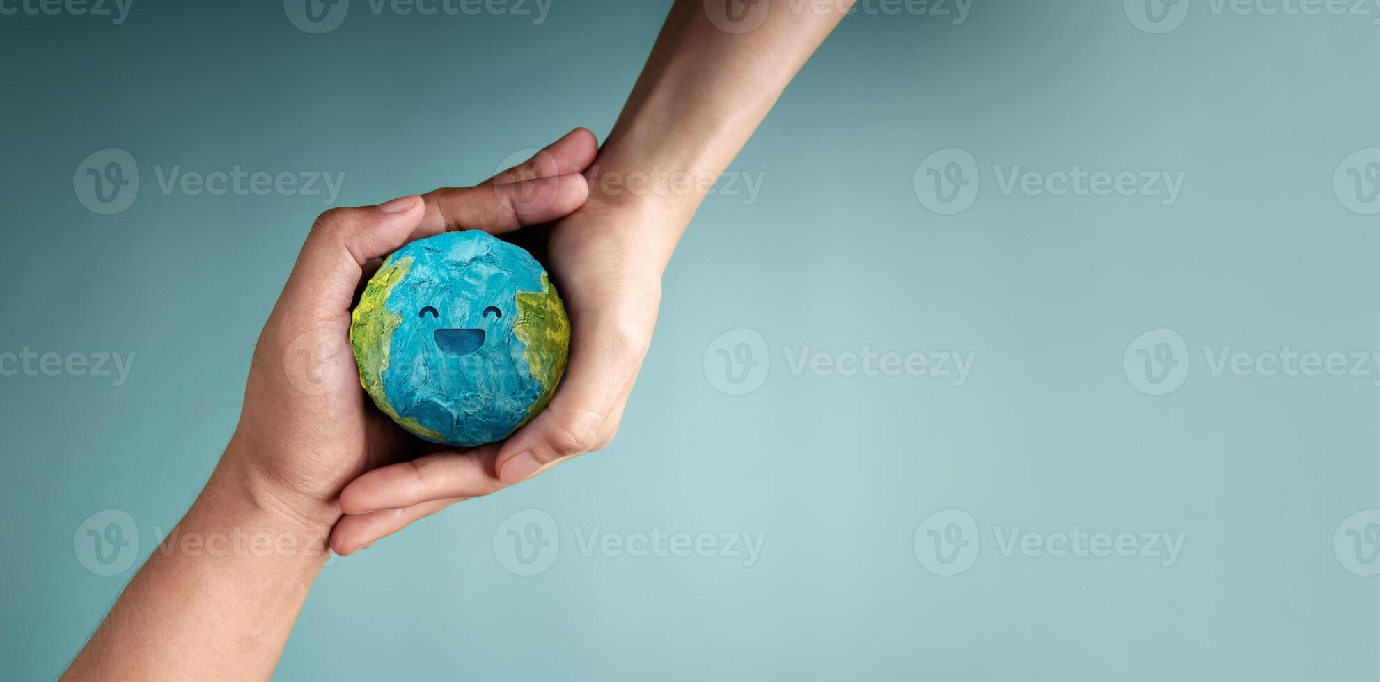 two people holding Happy Smiling Earth symbolizing sustainability, global happiness, environmental care, and ecological responsibility, Top View photo