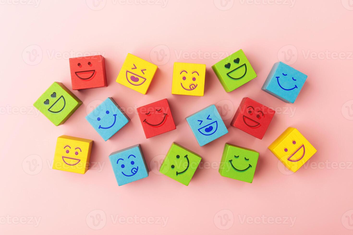 Group of Colourful Smiling Emoticon Diversity Face on Multi-colour Cube. Mind Mental Health. Happy Community. World Happiness, International Smiling Day. Table Top View photo