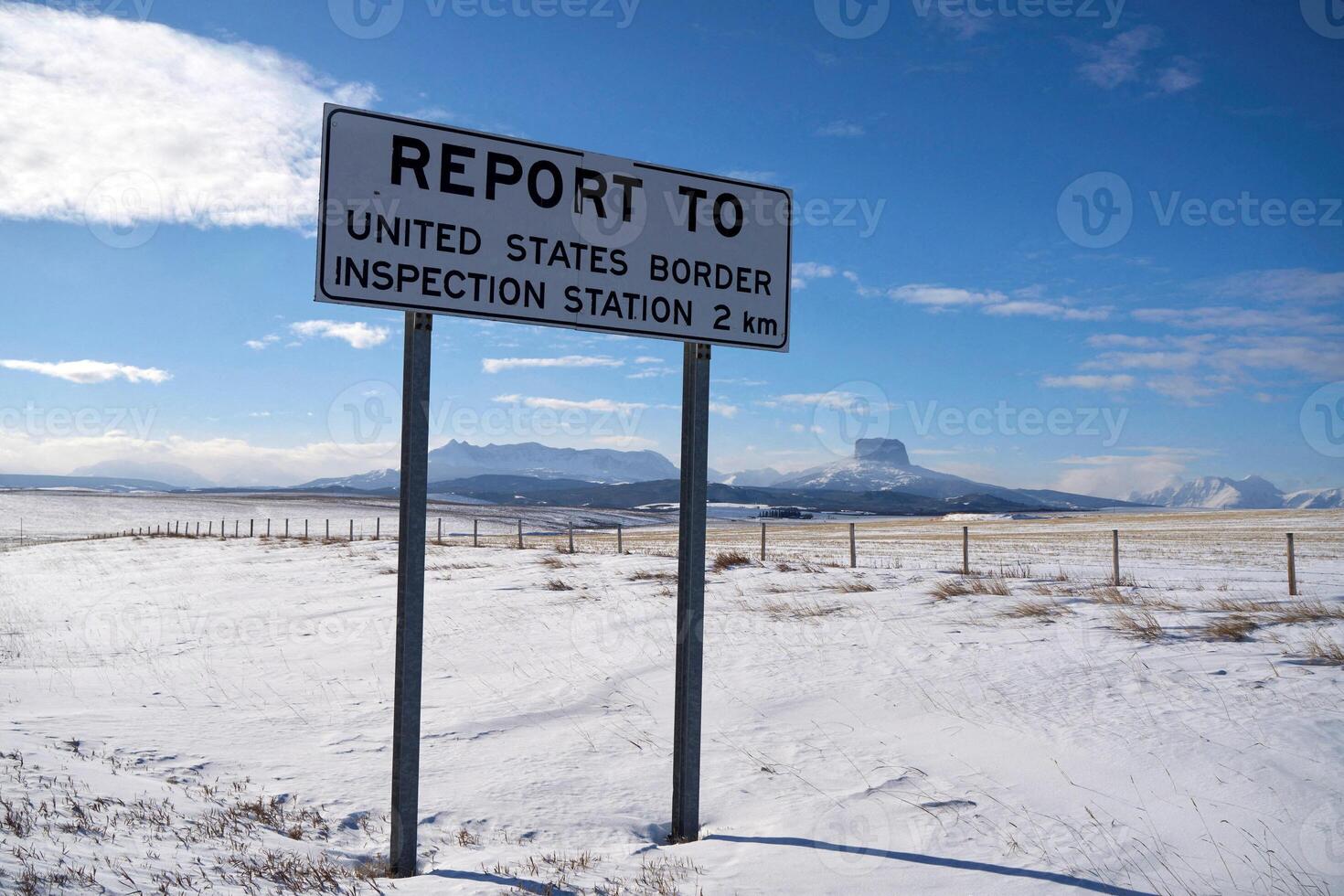 Snow-Covered Ground and Border Sign in Southern Alberta, Canada, Near Montana, USA photo