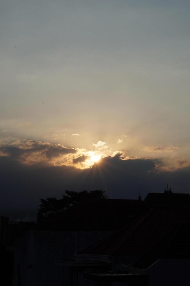 Afternoon sunlight in a city with the sky turning dark photo
