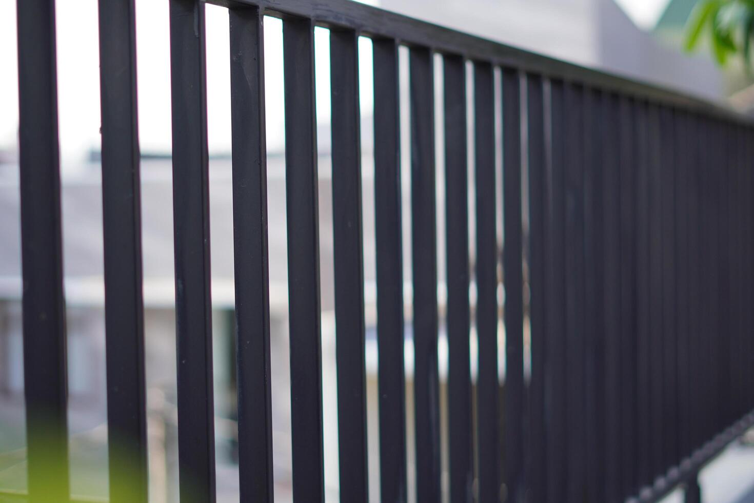 Black iron fence photographed from the side photo