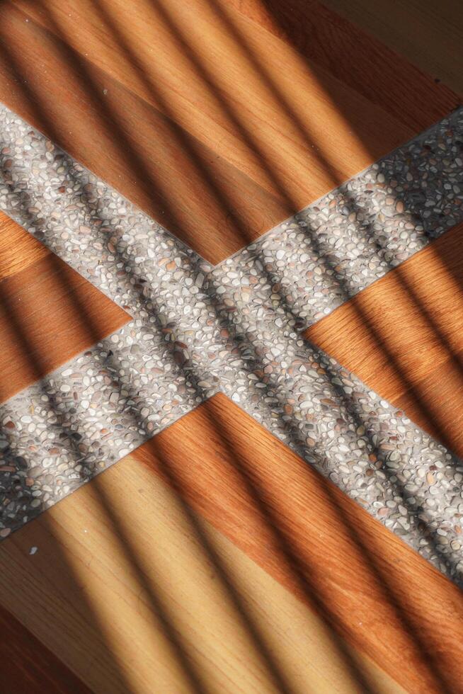 Shadows of oblique lines that hit the surface of the brown tiles with white lines in the afternoon photo