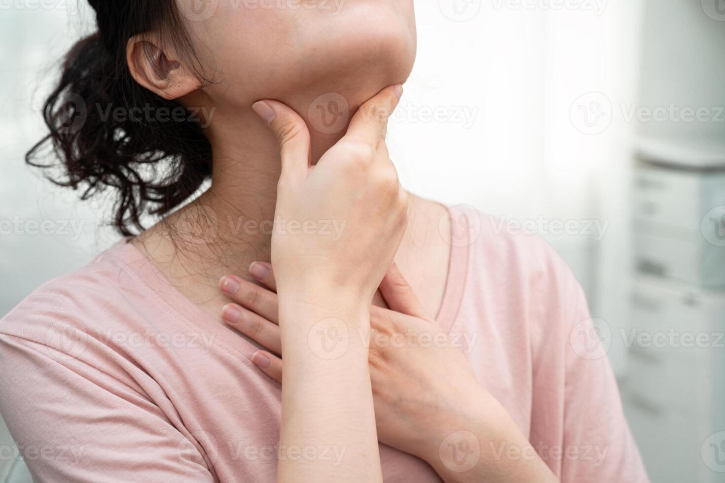 woman touching neck and throat thyroid gland problem. photo