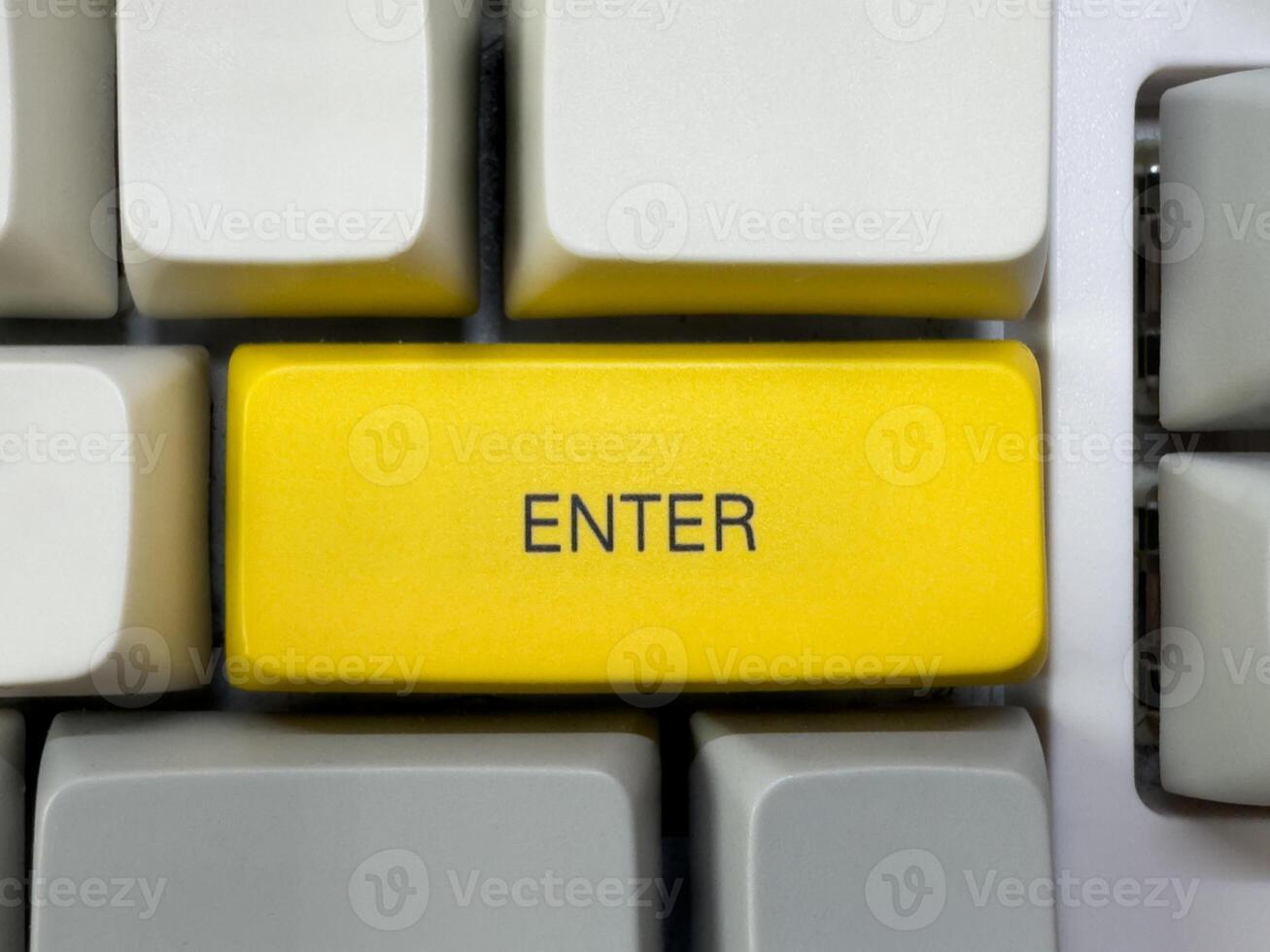 Big yellow Enter button with text on mechanical white keyboard, business concept, for advertising photo