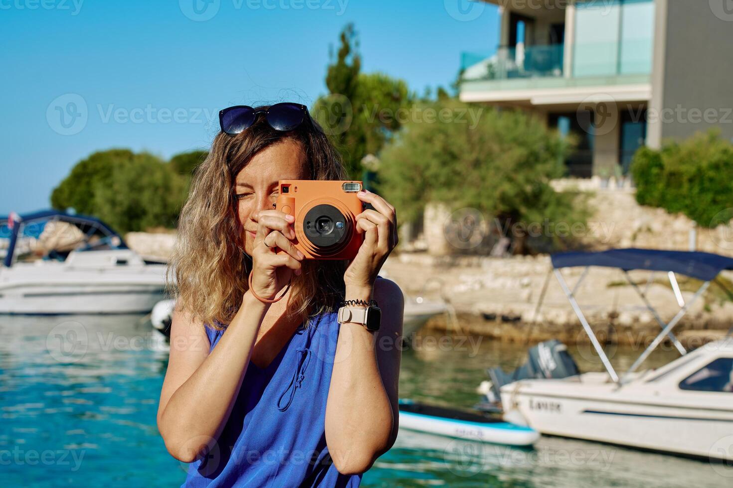 Woman using instant camera photo