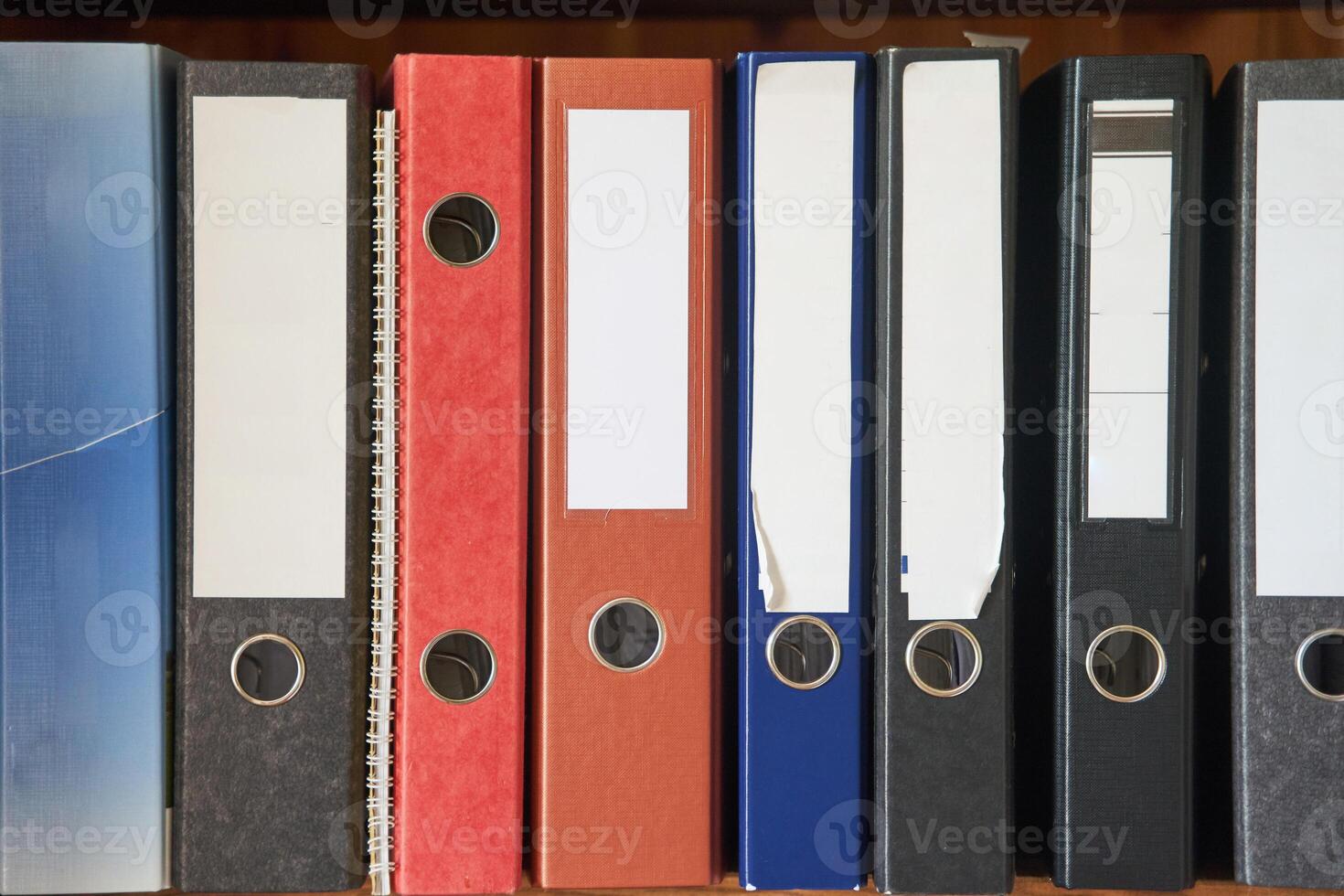Colored folders for office files and paper on a shelf. Background image photo