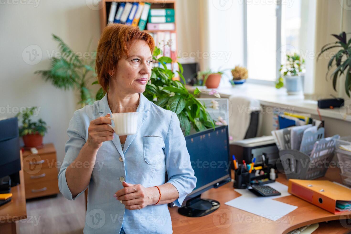 Woman taking a coffee break at her desk in a quiet office setting. Mindful pause, mental reset, and slow work lifestyle. High quality photo