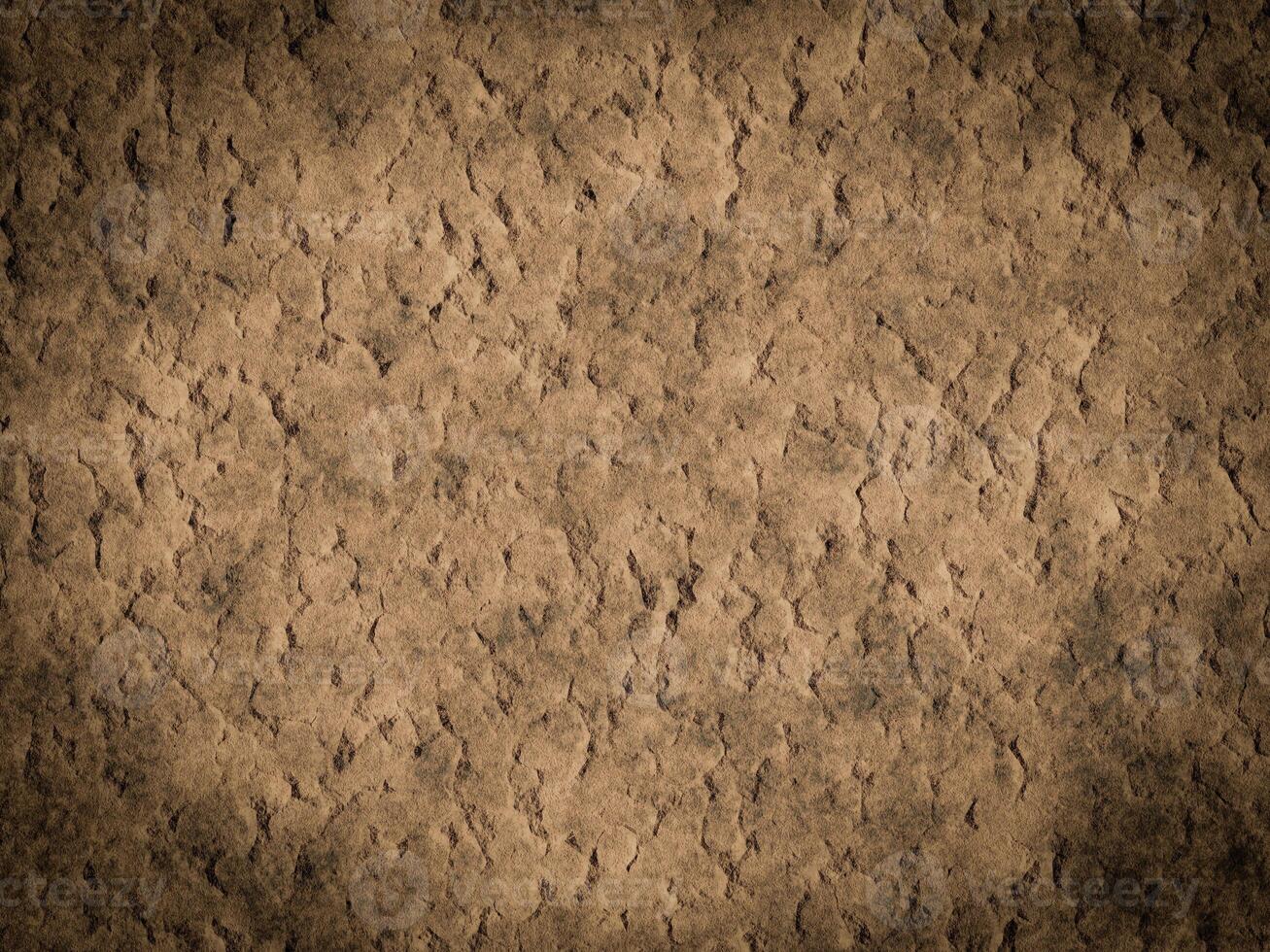 Rough cement texture with noticeable cracks and uneven surface patterns. photo