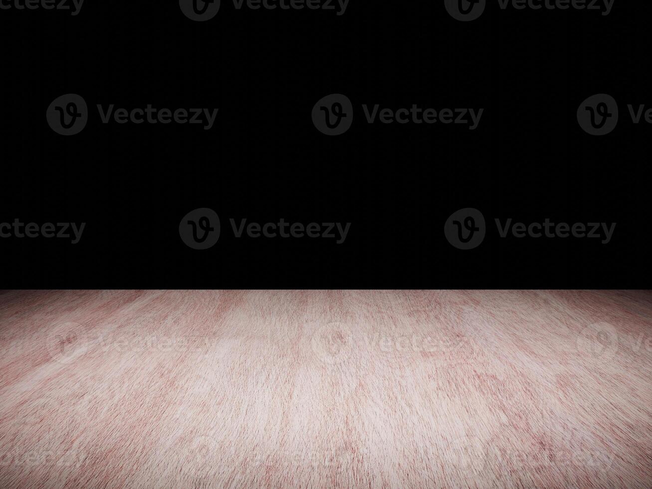 Dark wooden table surface with intricate grain pattern set against a black background. photo