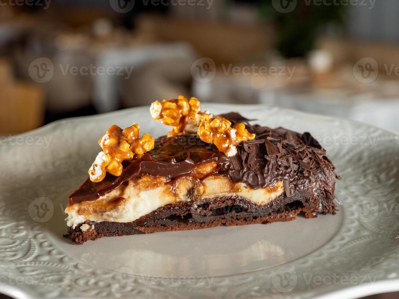 Chocolate caramel dessert slice on plate photo