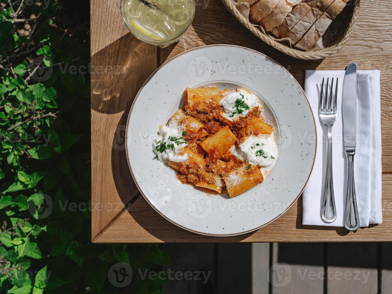 Pasta dish with sauce and herbs photo