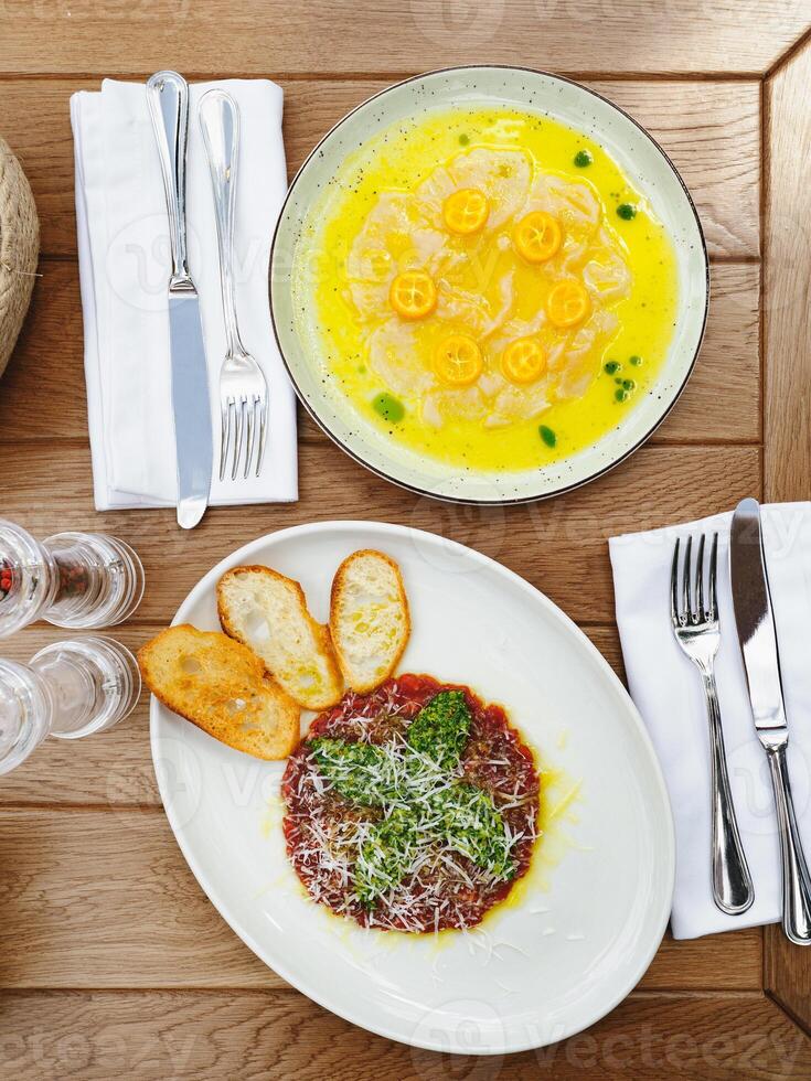 Gourmet dishes on a wooden table photo