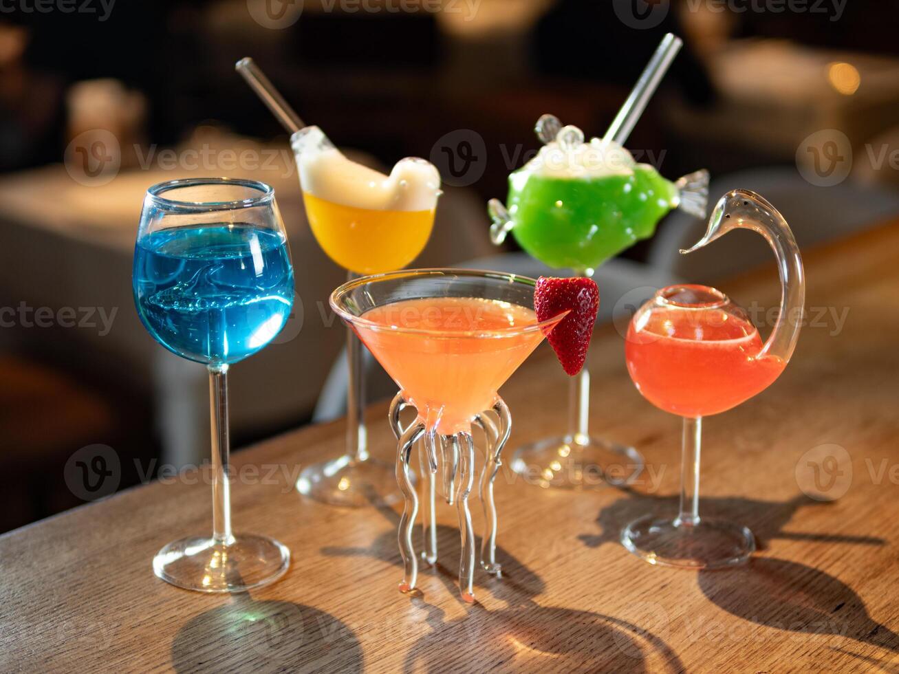Set of different colorful alcoholic cocktails - margarita, blue lagoon, cosmopolitan and other. Set of various classic cocktails on bar counter background. Selection cocktails and soft drinks photo