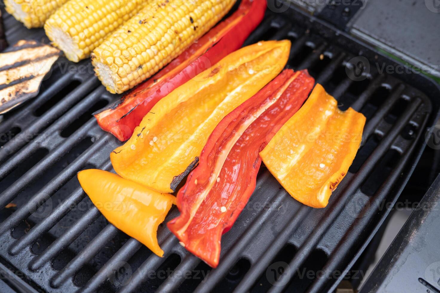 Grilled corn and bell peppers on bbq grill for a summer feast photo